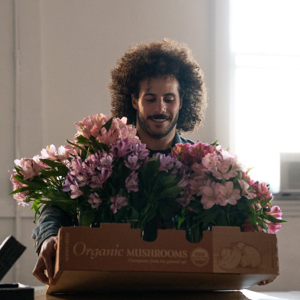 Mark setting down a case of flowers.