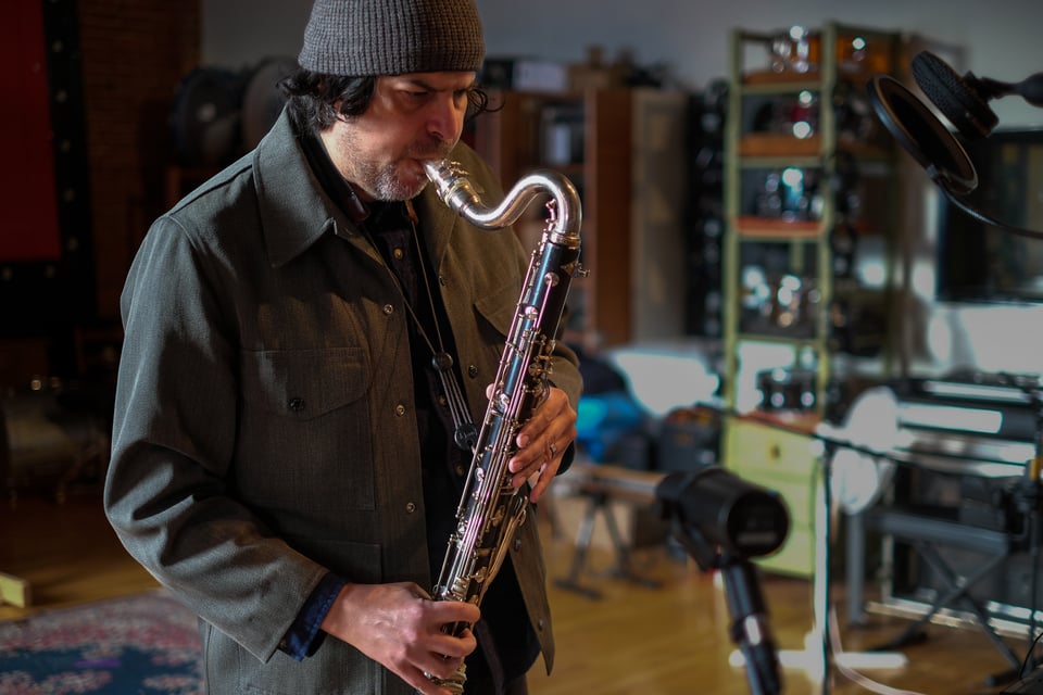 Musician Mark Cisneros playing a bass clarinet