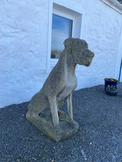 a larger than life stone sculpture of a dog, possible a Great Dane