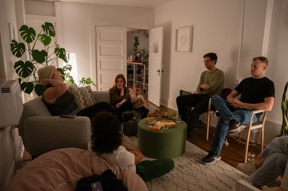 A group of people discussing a book.