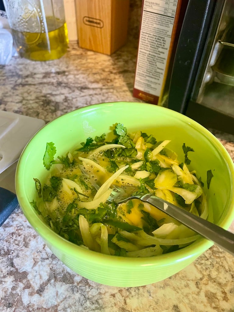 Raw onion, coriander and chili in an egg mixture
