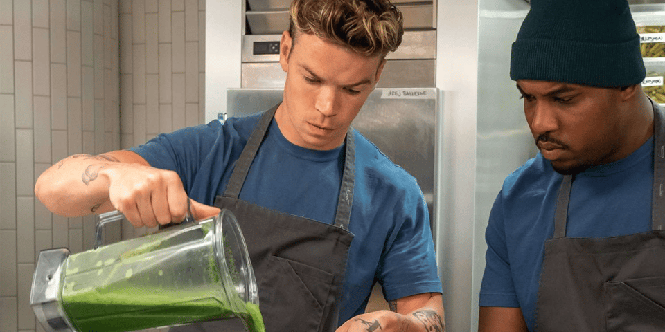 Two chefs pour out a green liquid.