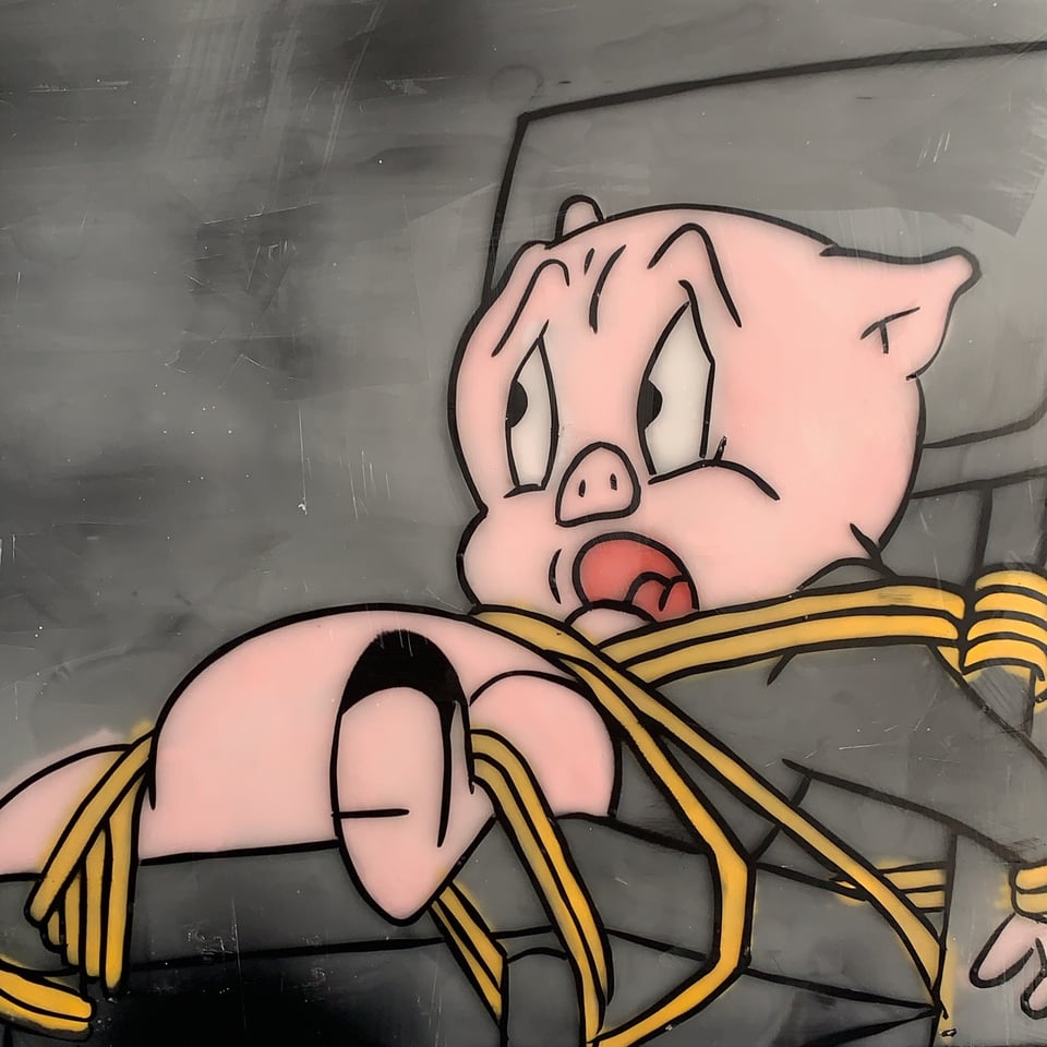 Porky Pig tied to a chair.