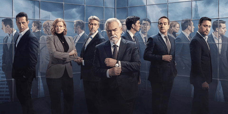 The entire cast of Succession in front of a mirrored wall.