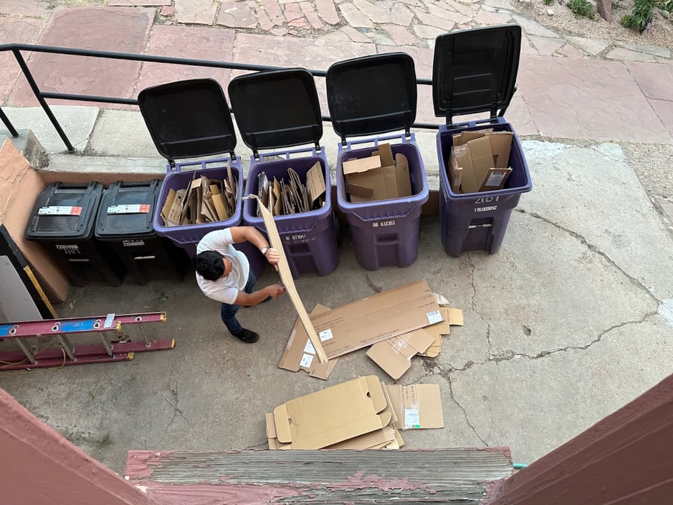 Norton cuts cardboard outside of The Company