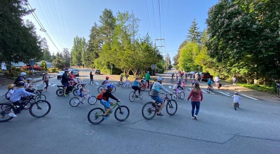 a group of kids riding bikes to school on a street