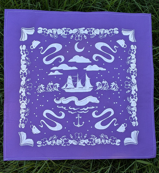 a purple square of fabric about the size and shape of a bandana, screen printed with white ink. The design has violets along all four edges, and each corner has an open book and a steaming cup of tea. In the center is a ship amidst high waves, below which is a giant eel and an anchor, and above which are clouds and a crescent moon. Stars are scattered around on the background.