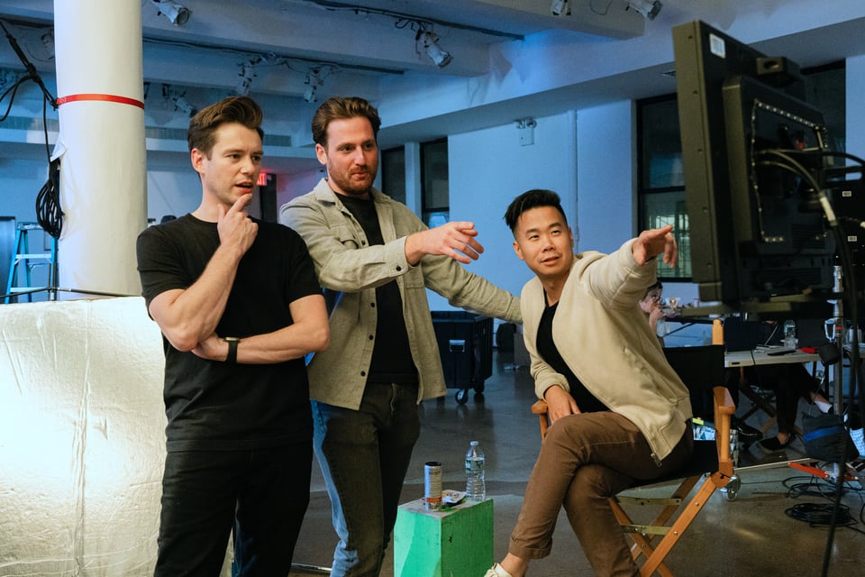 Justin Ayers, Andrew Soltys, and David Ma react to the camera monitor