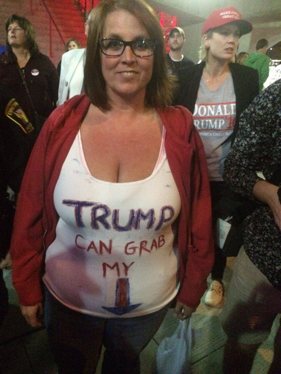 Woman wearing t-shirt that says "TRUMP CAN GAB MY PUSSY".