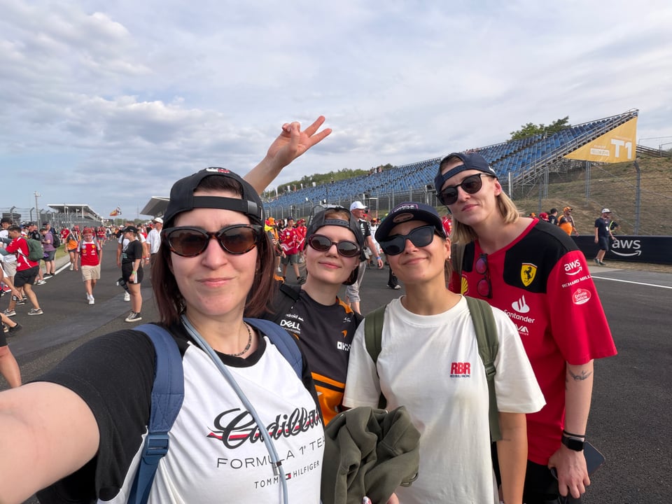 Four women taking a selfie on a race track