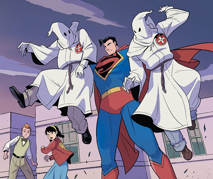 A panel from Superman Smashes the Klan, featuring Superman holding up two struggling, hooded Klansmen.