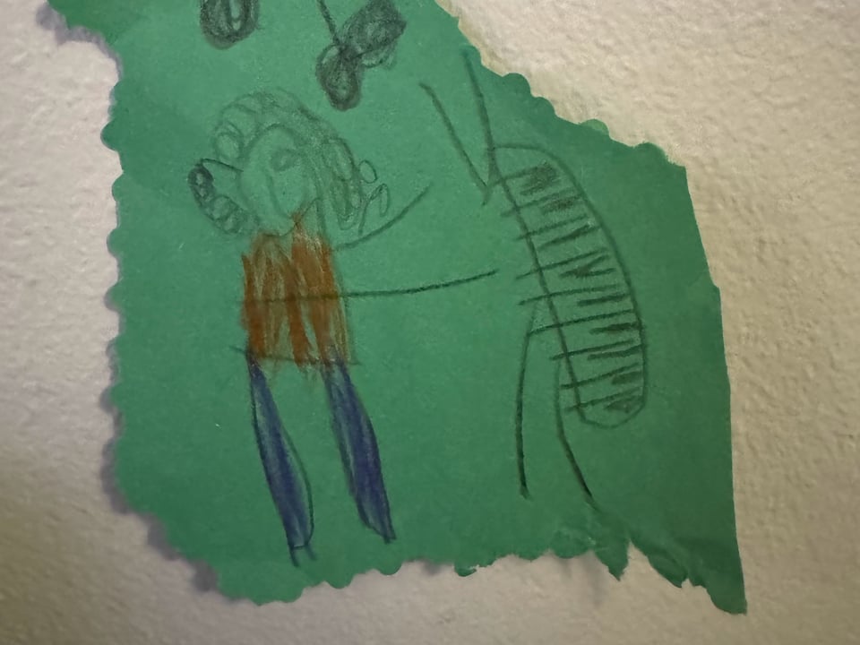a child's hand drawn image of a man with curly hair playing piano
