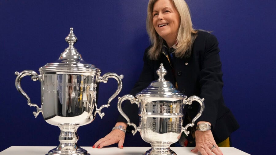 Stacey Allaster, U.S. Open tournament director and chief executive of professional tennis at the U.S. Tennis Association, poses for a photo with the women's keepsake trophy left, and presentation trophy, during an interview at the U.S. Open tennis championships, Wednesday, Sept. 3, 2025, in New York.