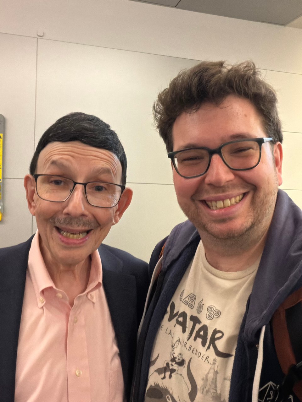 Marty and his Dad, who look very similar, smile for the cameras before leaving at the airport