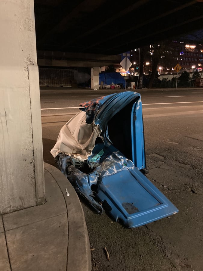 A mostly melted porta potty