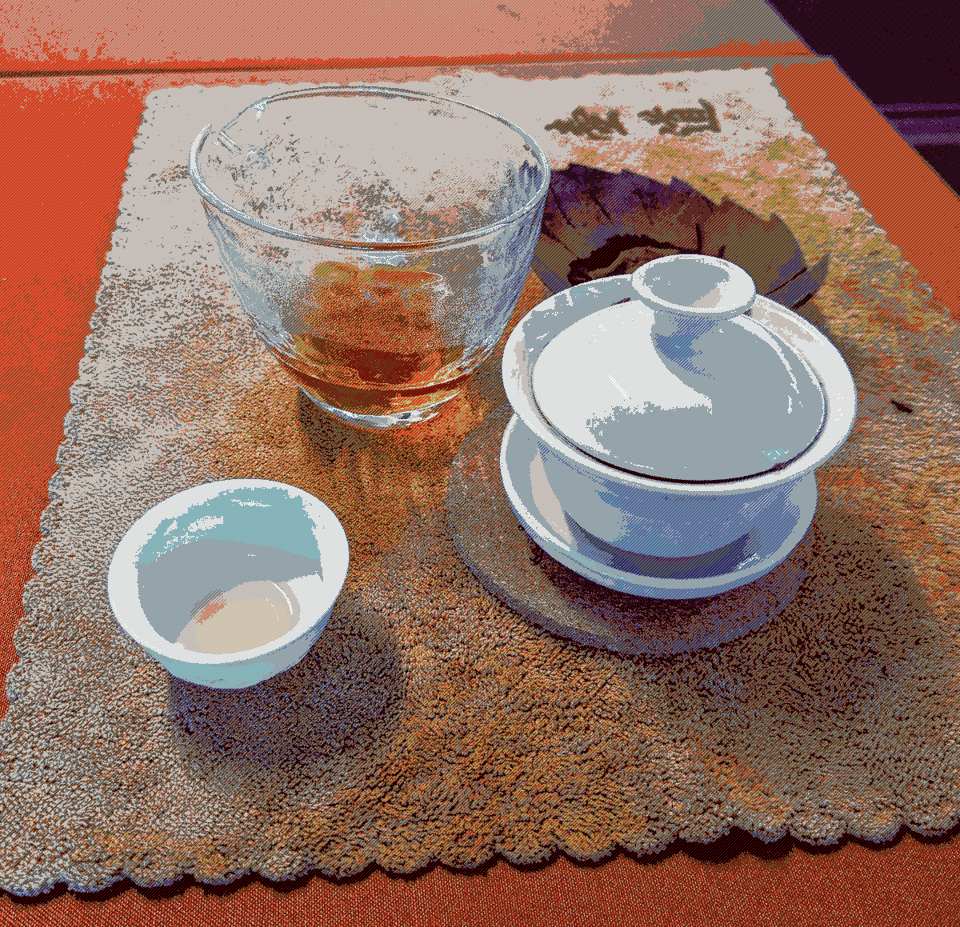 A chinese tea set and some amber-colored brewed tea.