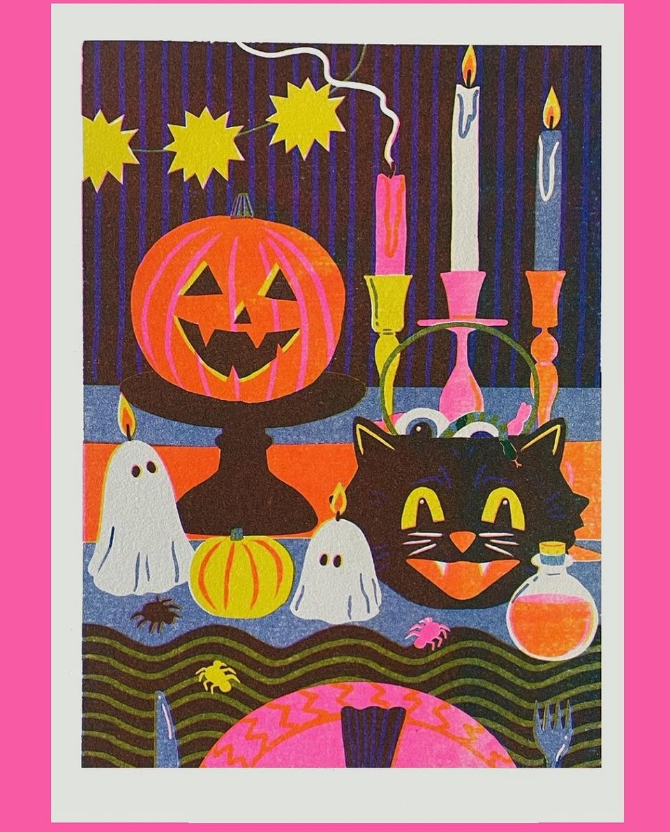 A risograph illustration of a vintage-style Halloween tablescape, with a jack-o-lantern, candles, a cat-head-shaped candy bucket, and ghost-shaped candles.