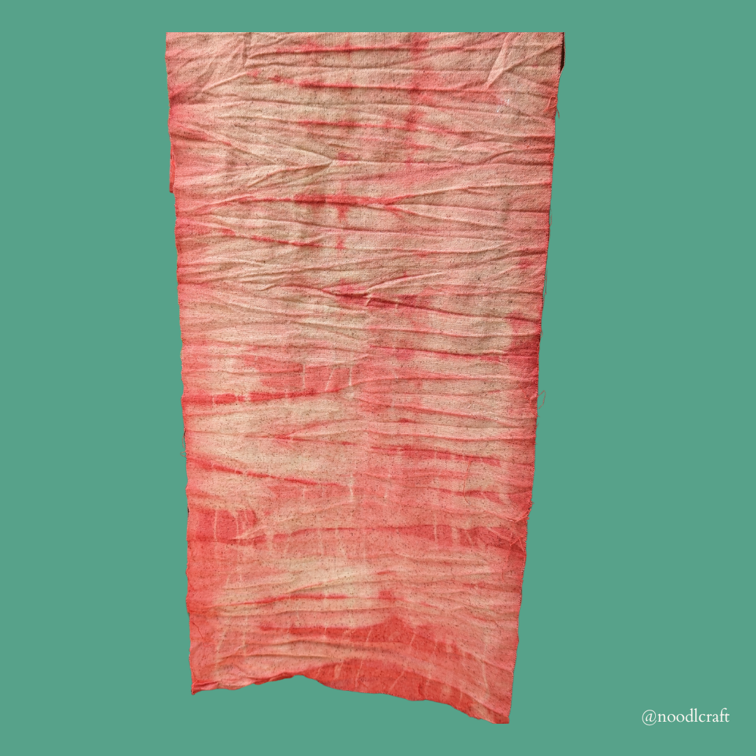 A picture of pink, dyed fabric with slight variations in hues. 