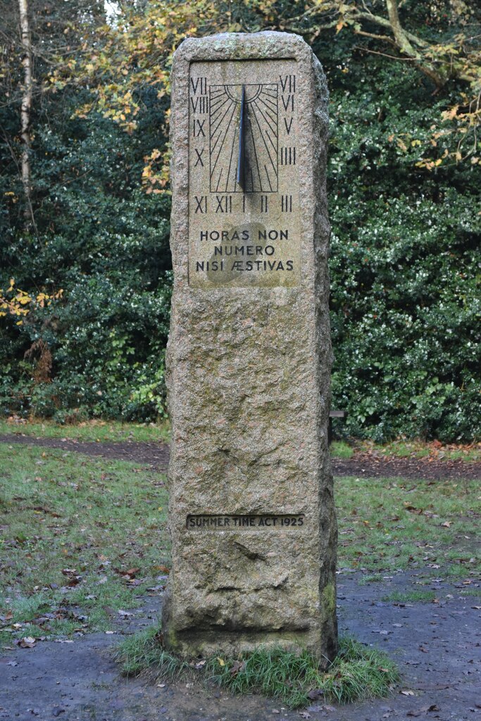 A stone monolith thing with a sundial on the front, and the words "HORAS NON NUMERO NISI ÆSTIVUS" and "Summer Time Act 1925", in a park