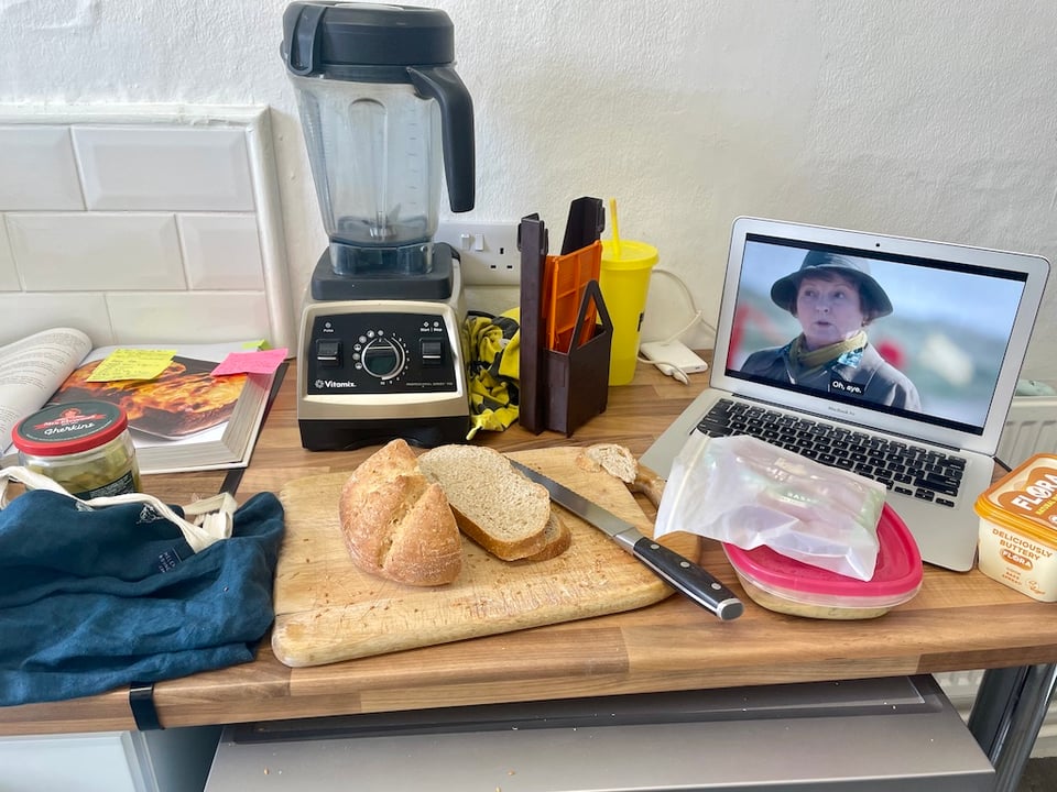 Sliced bread surrounded by various kitchen items. Vera on in the background.