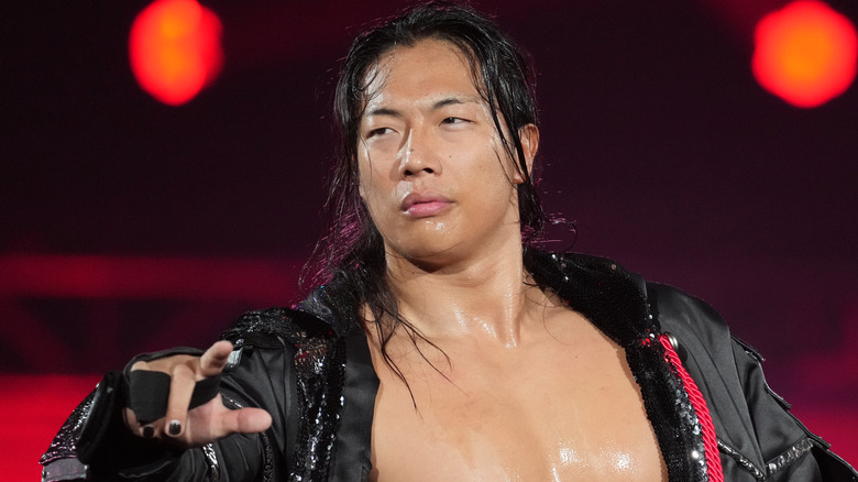 Konosuke Takeshita looking damp and surly during one of his pro wrestling entrances.
