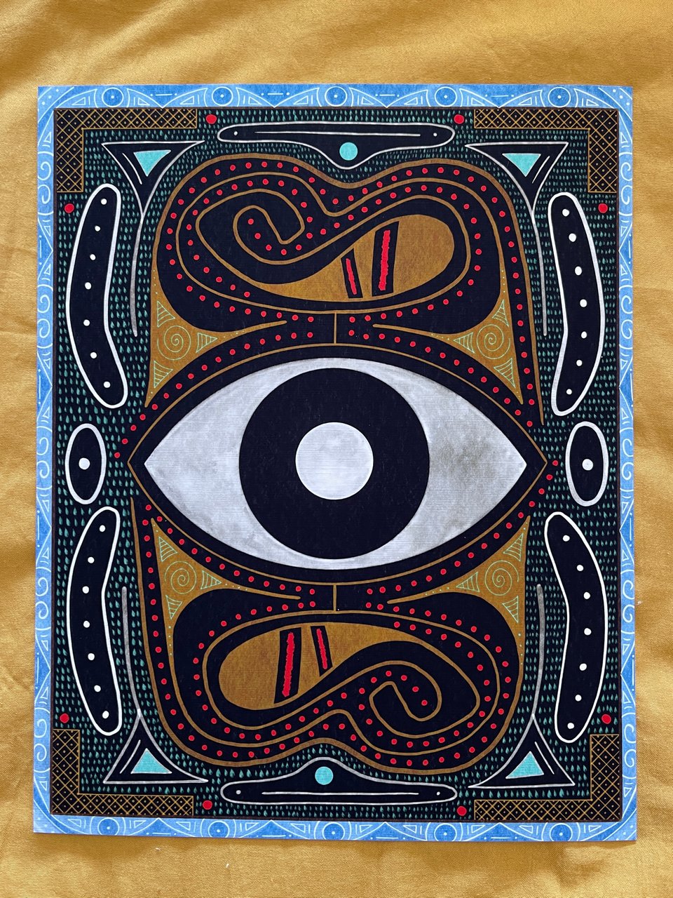 A colorful illustration with abstract geometric designs. An eye is in the center.