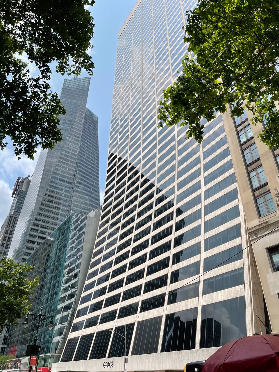 A curved glass building across the street from the library