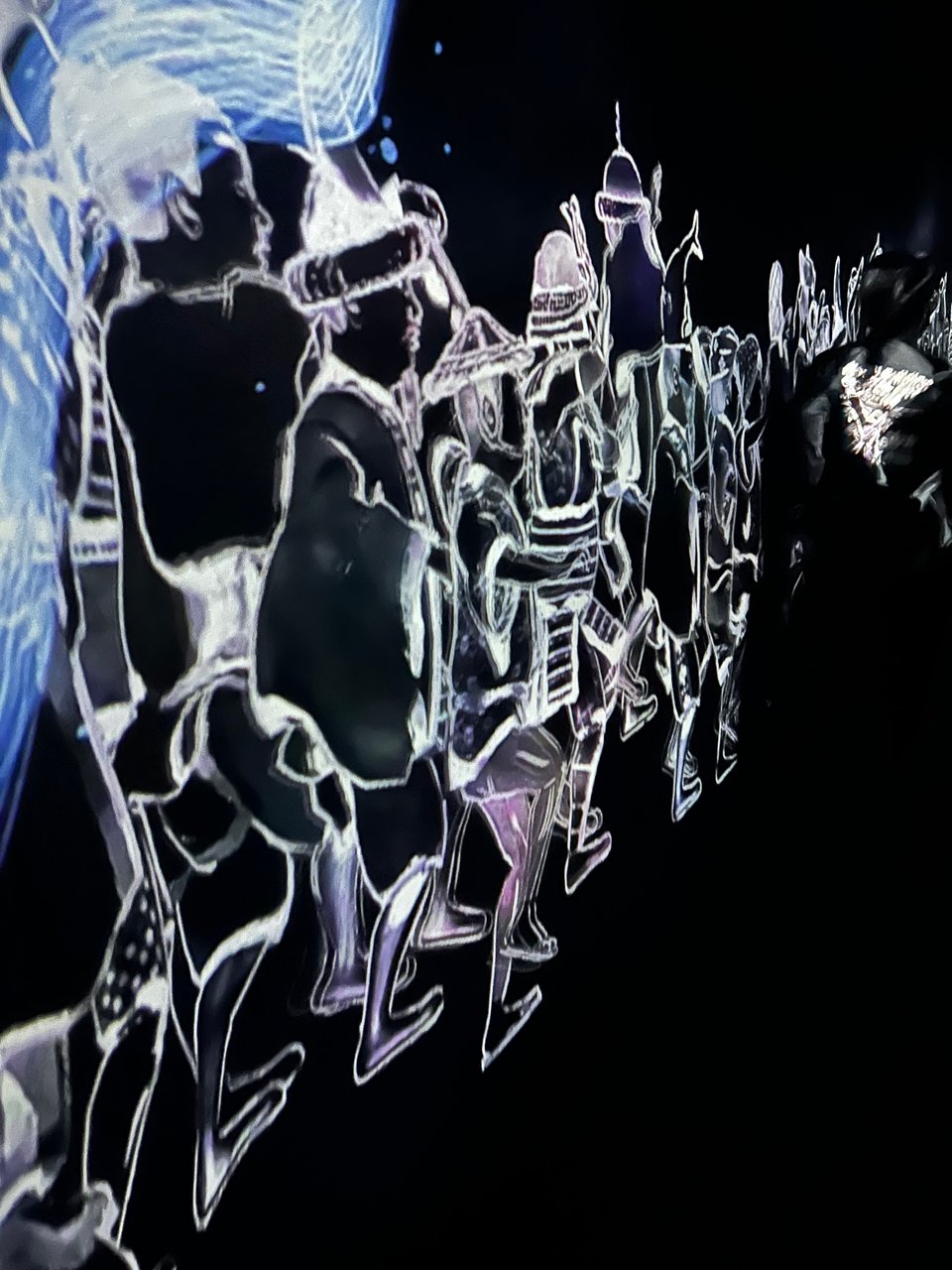 a digital display of fantastic figures from Japanese history and mythology moves along a black wall.