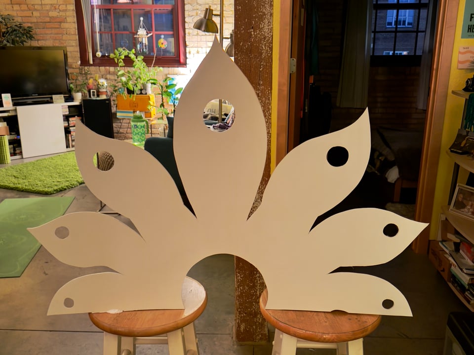 White lotus display sitting on two stools inside an apartment