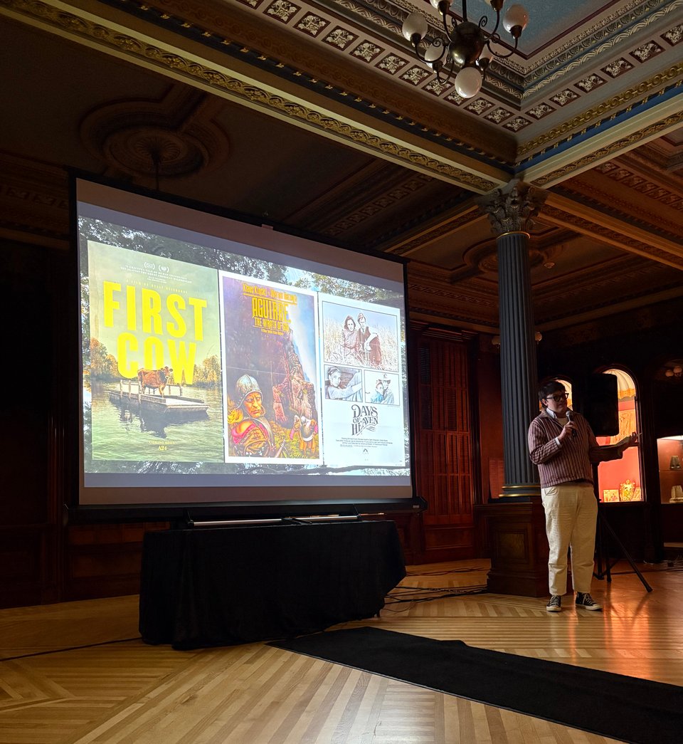 Jordan Mata presenting the three film options to the audience in the ballroom at the Crocker Art Museum.