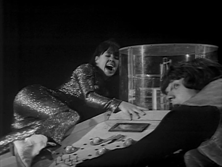 Zoe and Jamie clinging to the TARDIS console for dear life in an endless dark void.