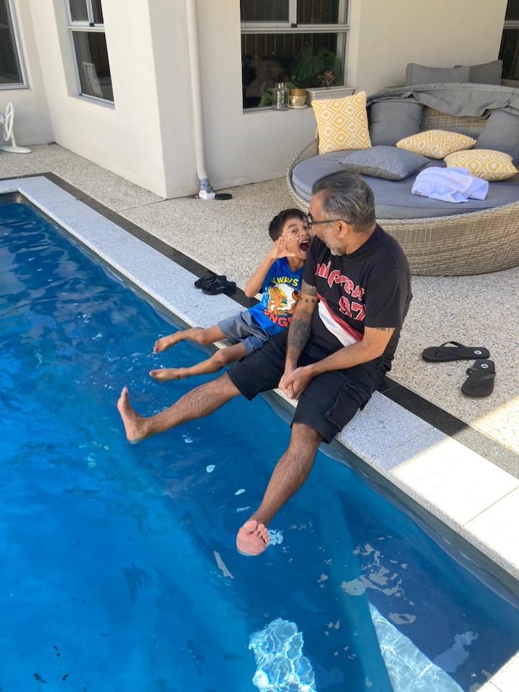A photo of my nephew and I by the side of a pool
