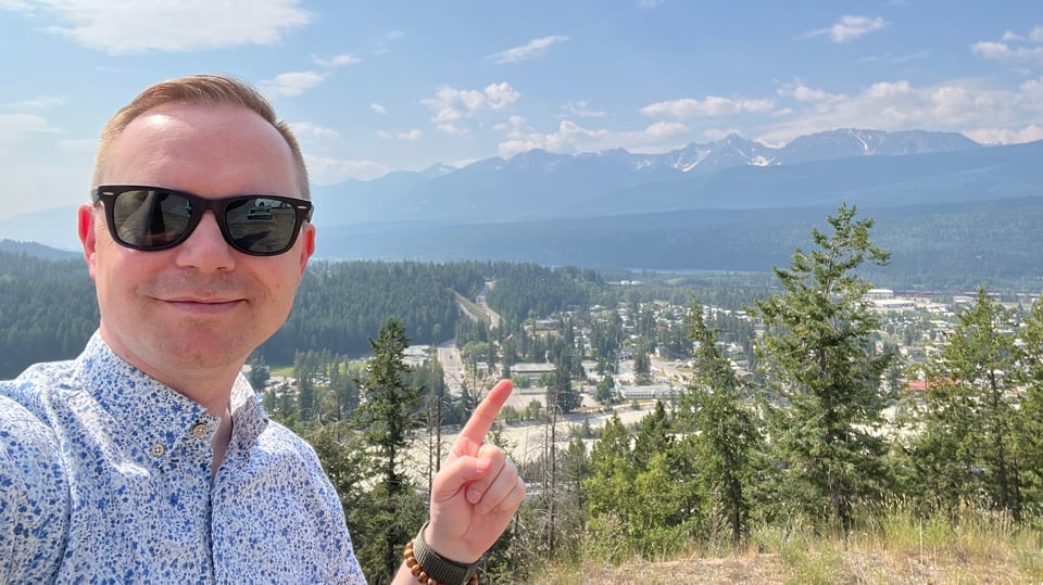 Chad at the Golden lookout, pointing to the town below