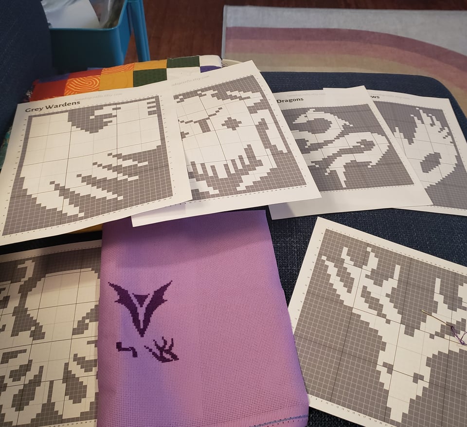 the resultant mess from me trying to cobble together a Veilguard Faction cross stitch out of a knitting pattern where all the faction symbols are separate files.