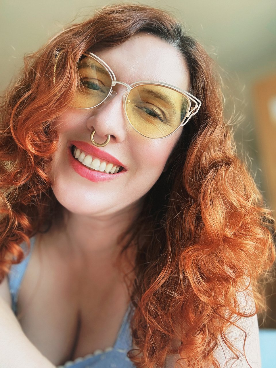 red headed woman smiles at the camera