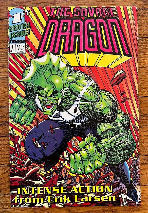A copy of The Savage Dragon vol. 1, #1, by Erik Larsen, on a hardwood floor. Cover features a big muscular green guy with a fin on his head.