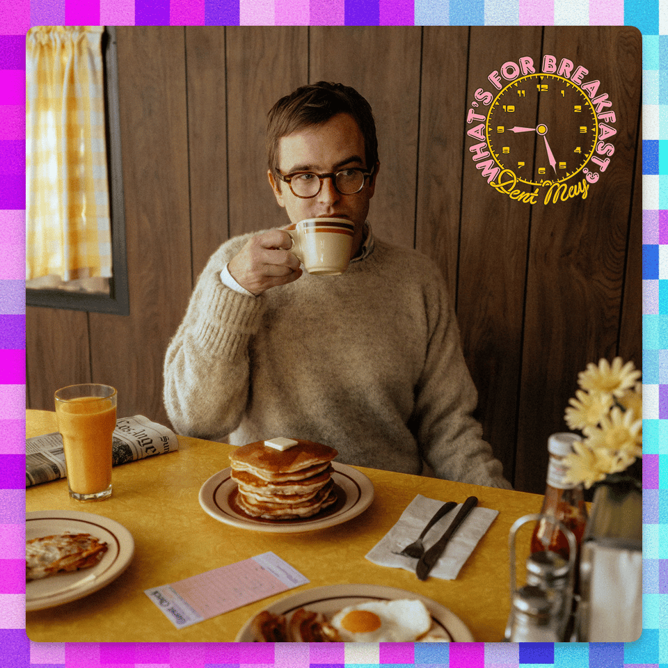 a man sitting at a table with a cup of coffee and a plate of pancakes as an album cover