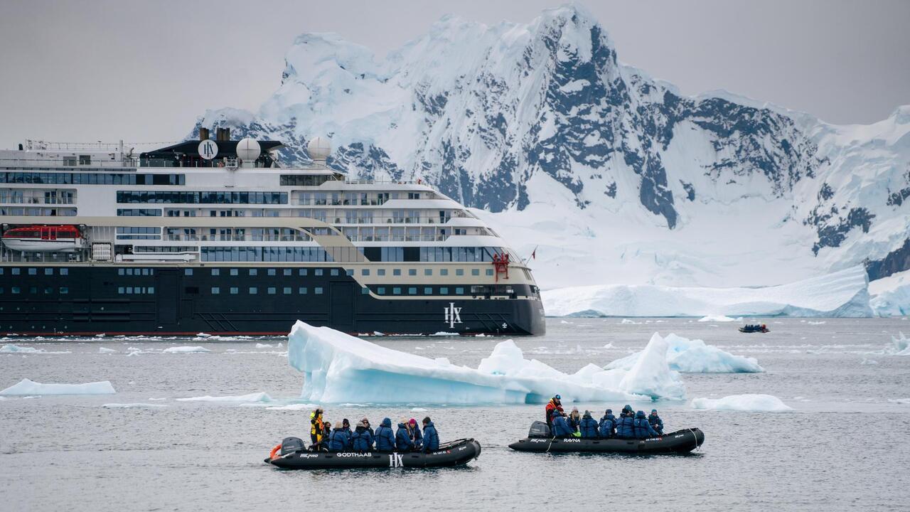 HX expedition ship with Zodiacs among icebergs