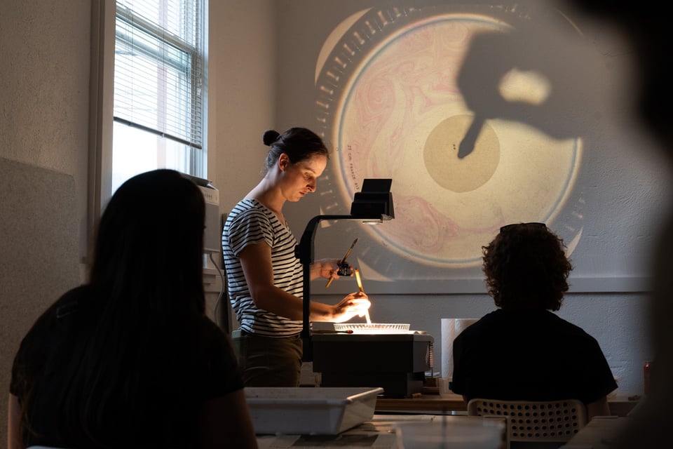 June demonstrating paper marbling using an overhead projector.