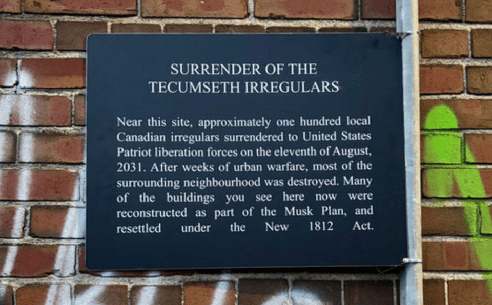 Aluminum sign mounted on a brick wall with text from a fictionalized history of the US invading Canada