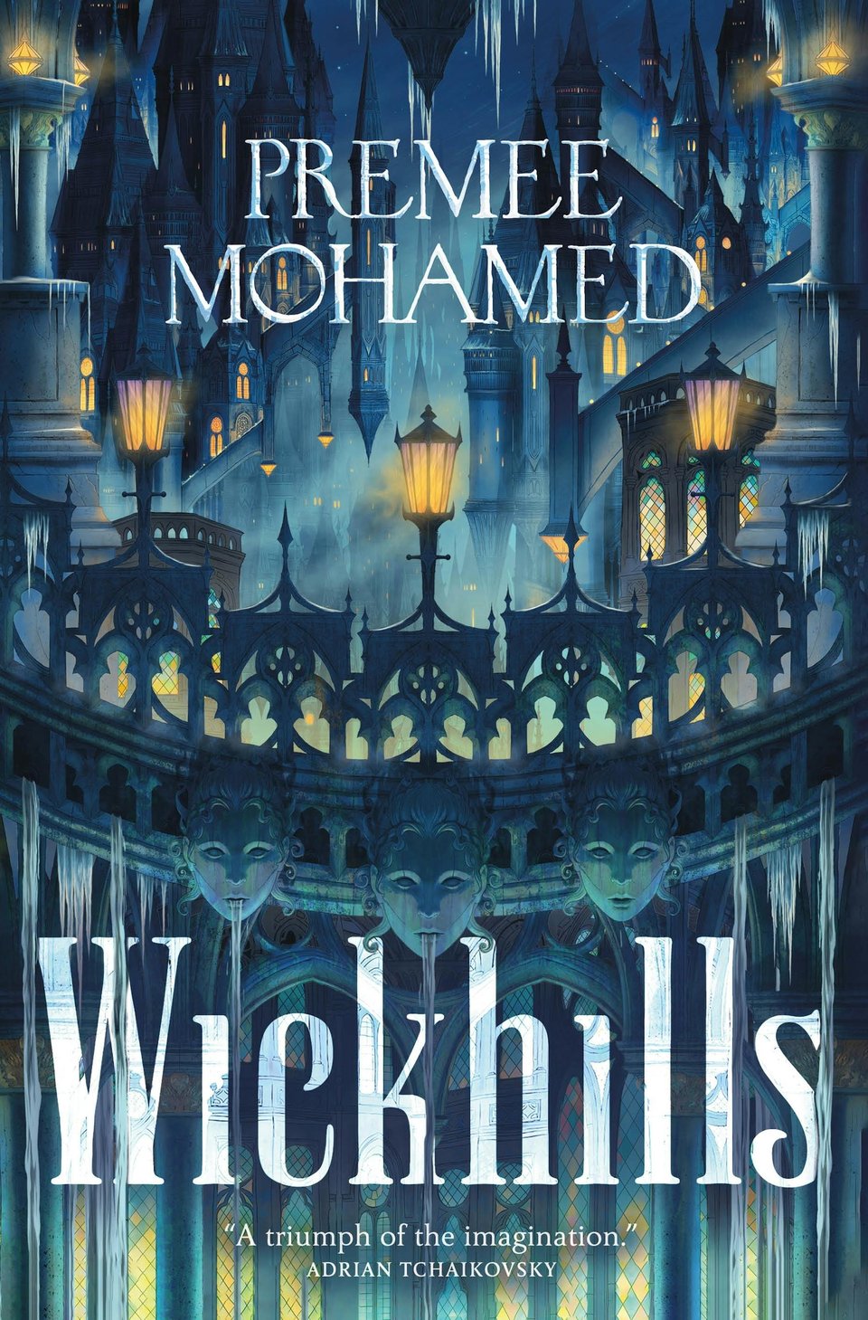 Cover of Wickhills be Premee Mohamed. The foreground is the edge of some kind of building with busts of three faces. There's some kind of growth hanging from everything. In the background, a huge city rises, lit by yellow street lamps.
