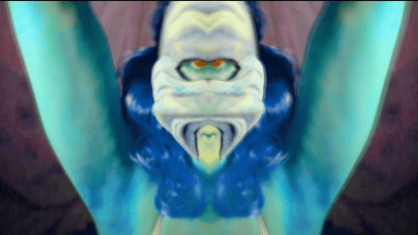 Still from Sara Tuss Efrik's 'Persona Peep Show' - a colourful masked figure.