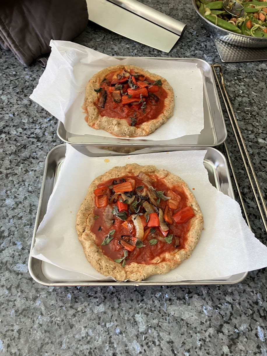 Two homemade vegetable pizzas