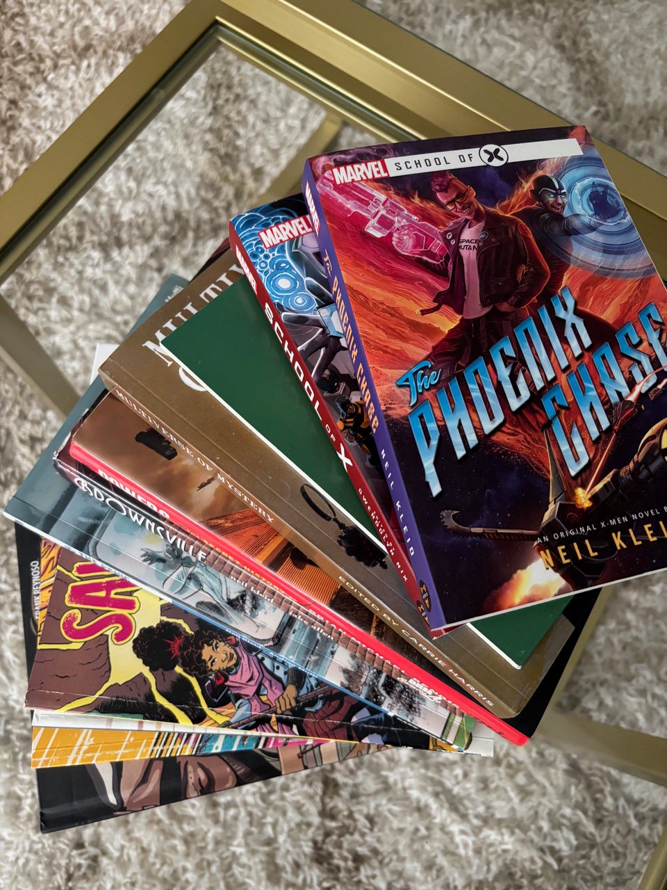 a coffee table with a bunch of neil kleid penned books