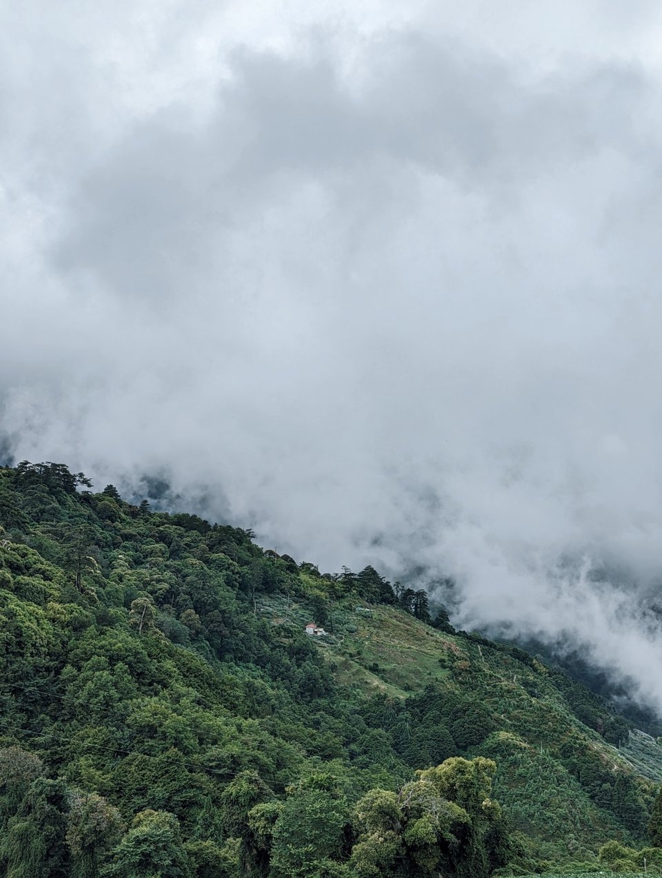 Rolling clouds over grassy mountains