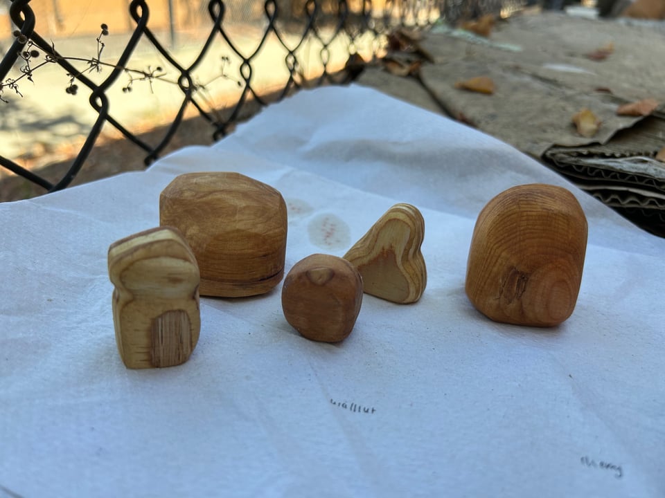 a bunch of little wooden pebbles