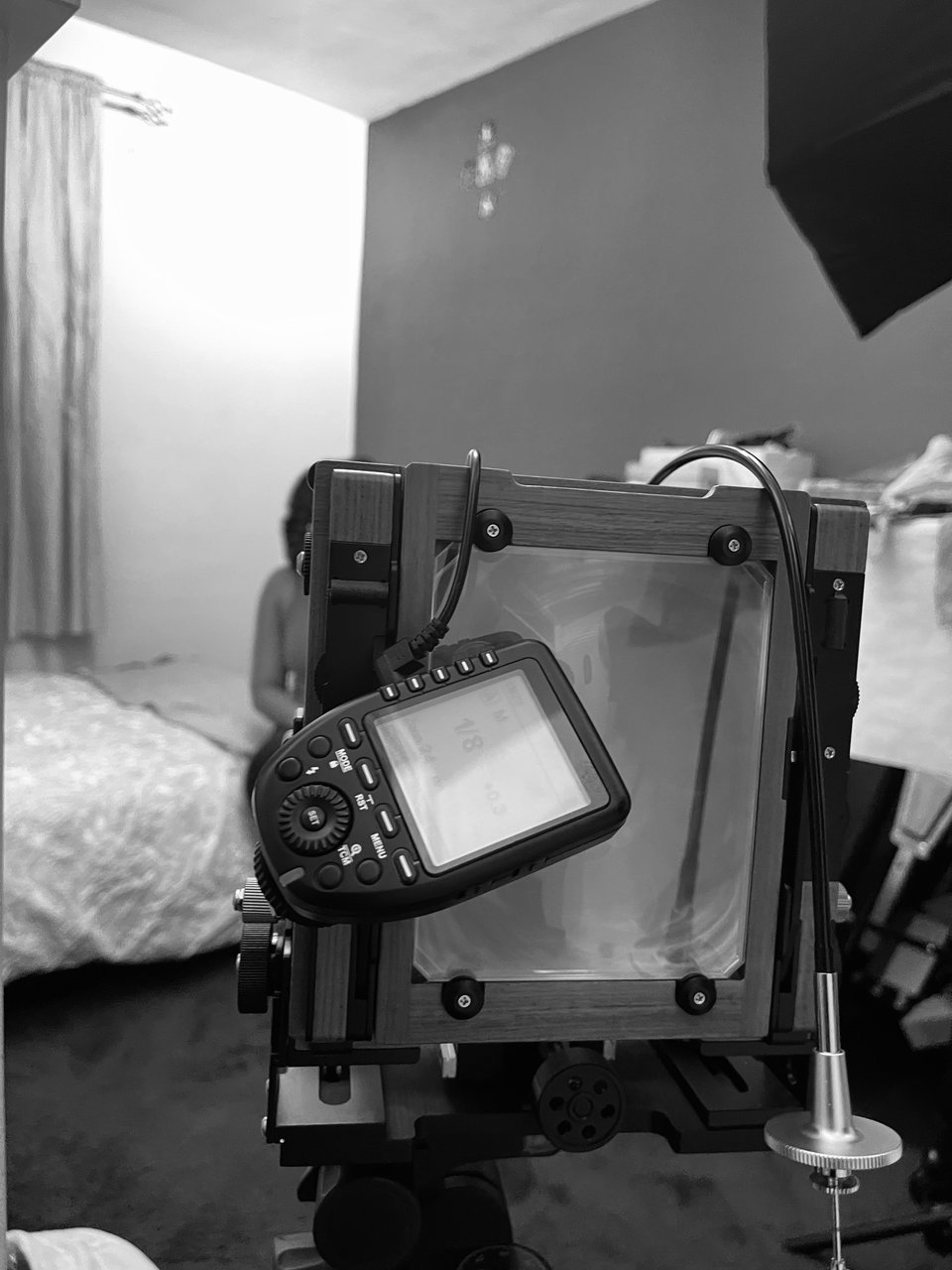 a camera on a tripod in a bedroom