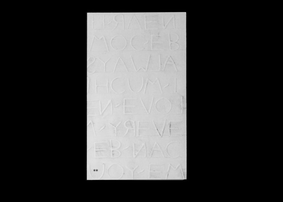 White letters on a white cover, with traces of graphite and smudge marks around the raised letterforms, reminiscent of a rubbing.