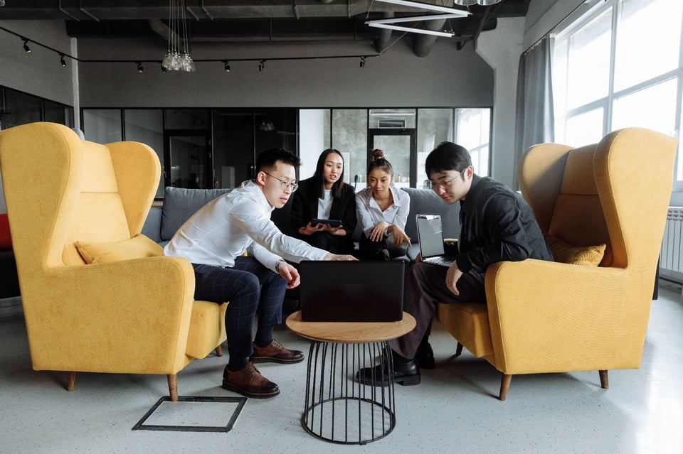 Photo of four people having a meeting