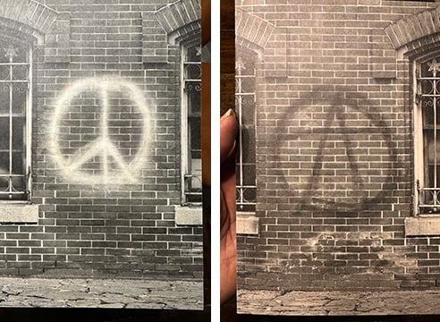 a peace sign and anarchy symbol spray painted on brick walls in Washington DC